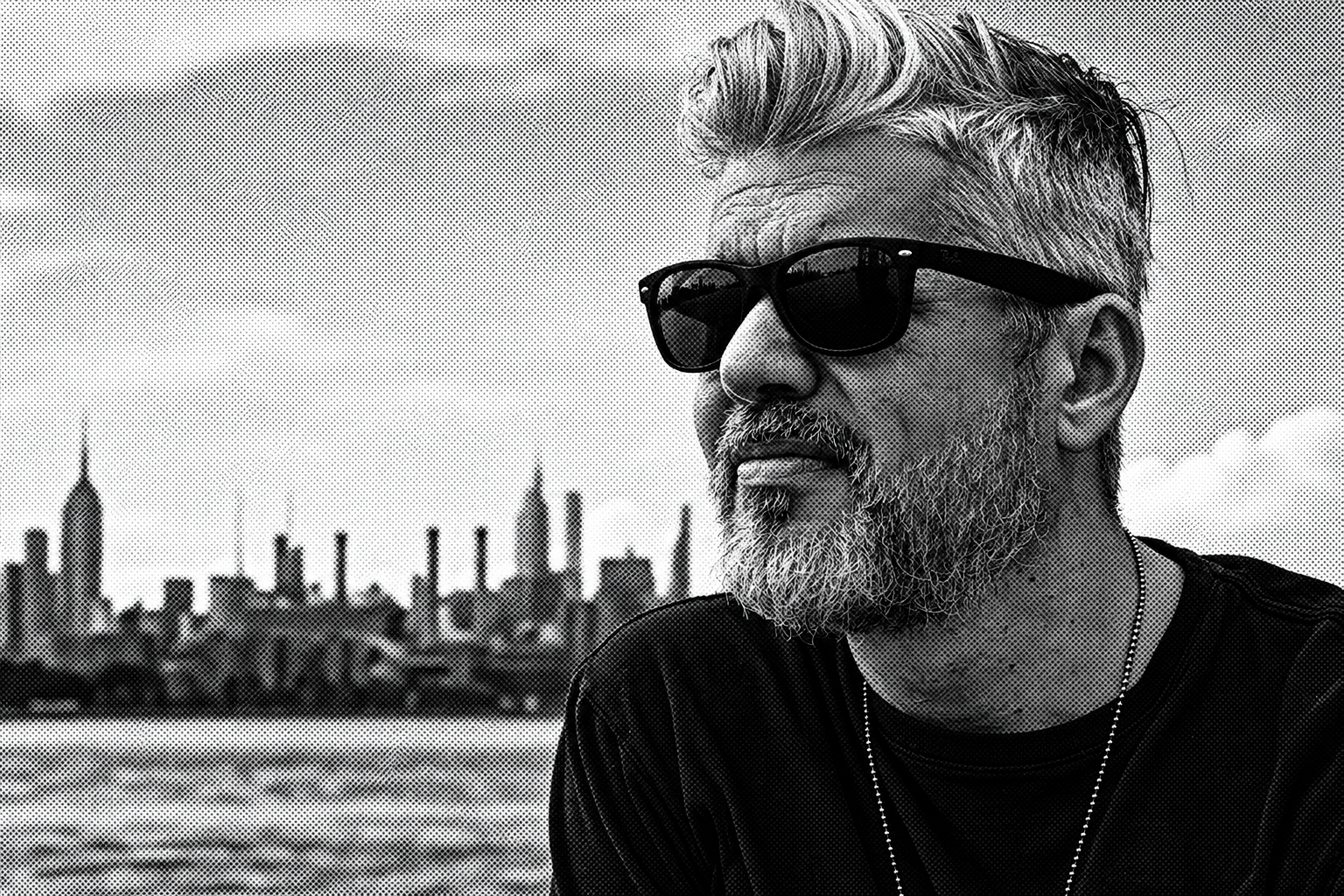 Grayscale halftone portrait of Brian Burnside with the New York skyline