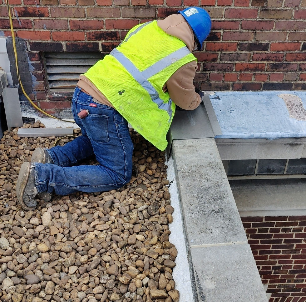 Roofer making commercial roof repairs on coping.