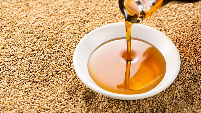 How To Do Ayurvedic Oil Pulling and Its Benefits image bowl of sesame oil and seeds