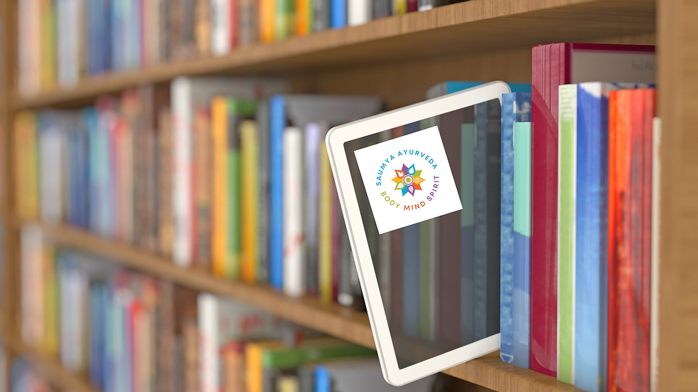 Tablet with "Saumya Ayurveda Body Mind Spirit" logo on a colorful bookshelf, conveying a sense of knowledge and wellness.