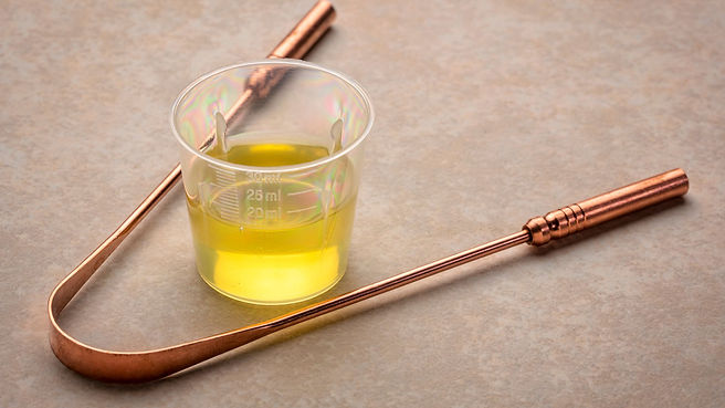 How To Do Ayurvedic Oil Pulling and Its Benefits image tongue scaper and seame oil