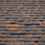 Close up of brown and black shingles Roofing Services on a roof