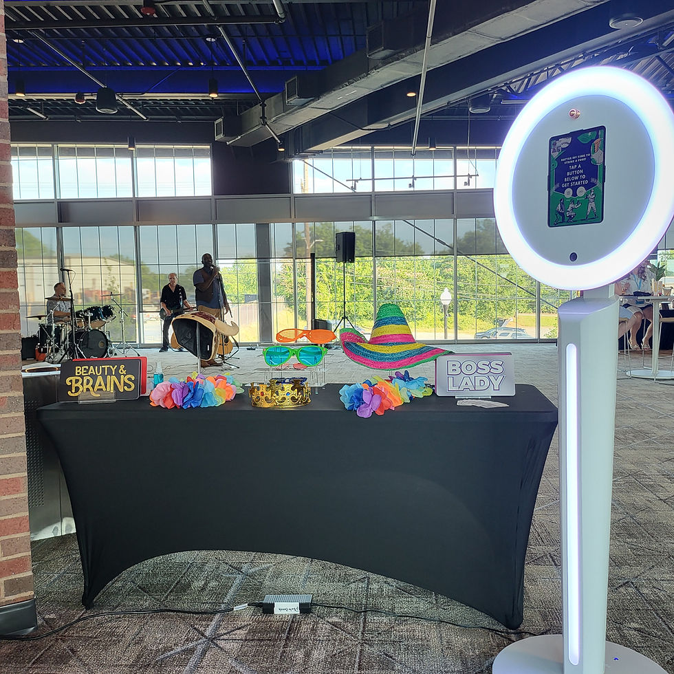 Digital photo booth with ring light and props table.