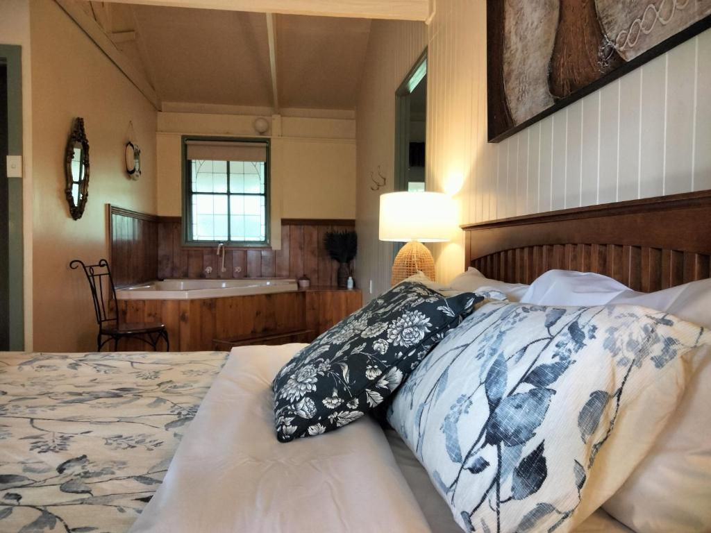 Bedroom with floral pillows and indoor hot tub