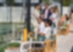 Guests enjoying drinks and socializing while watching padel matches at Padel Club Palm Beach.