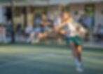 Female padel player competing on the court with an audience watching at Padel Club Palm Beach event.