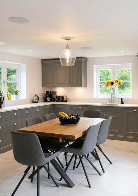 A handmade, shaker-inspired kitchen with dark grey cabinetry, satin nickel handles, beautiful oak features and bespoke kitchen details