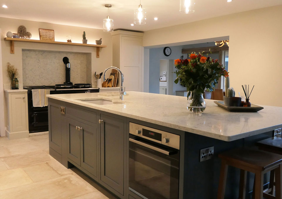  A handmade, luxurious shaker-inspired kitchen with a neutral run of cabinetry and a blue kitchen island. We also crafted a shaker utility room with neutral cabinetry and an oak worktop, some free-standing neutral cabinetry and a boot room with a simple run of dark blue shaker cabinetry.
