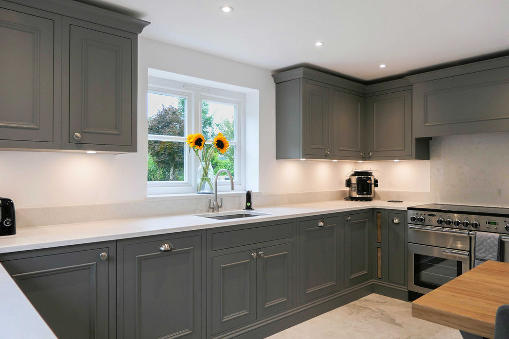a handcrafted bespoke shaker kitchen with dark grey kitchen cabinetry, innovative storage soloutions, bespoke oak detailing and classic shaker features throughout the design