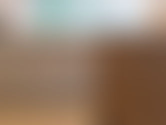 a handcrafted bespoke kitchen with light grey perimeter cabinetry and a custom walnut kitchen island