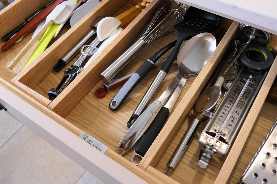 A handmade shaker-inspired kitchen crafted for a beautiful country home; with soft, neutral cabinetry and iron handles it is the perfect country kitchen. This kitchen design features innovative storage solutions, a bespoke larder, rustic Oak features and bespoke kitchen details.