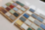 a wide selection of kitchen cabinetry colour samples laid out on a quartz worktop