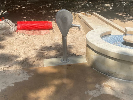 Newly installed stainless steel splash fountain pump at Hemisfair Park in San Antonio, TX by Rapid Plumbing, with mosaic splash pad visible in background