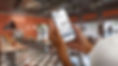 Person holding a smartphone with a Good2Go virtual queue on the screen.