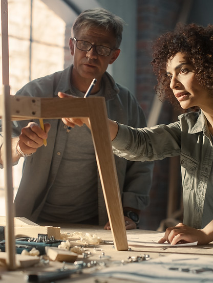 Portrait of Two Small Business Owners Working Together on Creating a New Wooden Dining Tab