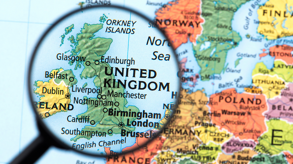 Map of the UK is magnified, showing cities like London, Edinburgh, and Dublin. Colorful map background with surrounding countries visible.