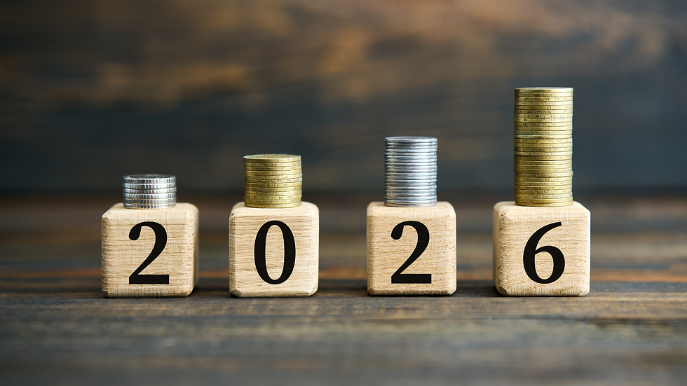 Wooden blocks spell "2026" with coins stacked on top, increasing in height from left to right. Dark wooden background.