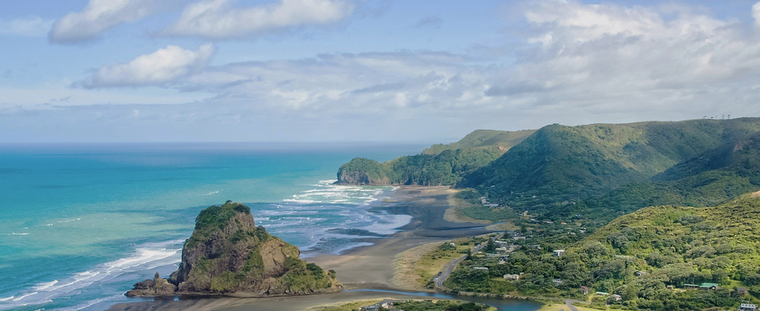 Panoramic view of Piha Beach and Lion Rock on Auckland's West Coast Tour.