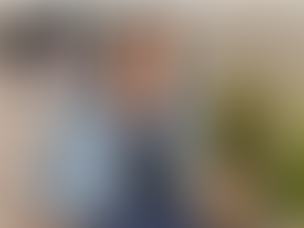 Rachel Erickson leaning back and smiling under the Unmarked Street logo