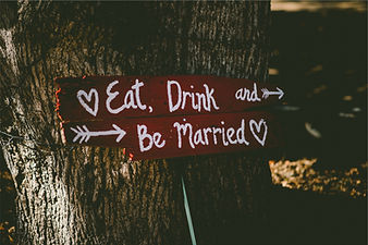 Wedding videographer filming sign at wedding venue in dahlonega ga Eat Drink and Be Married sign
