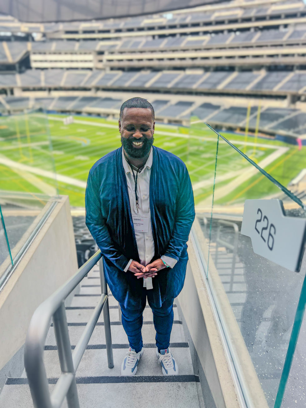 a man stands on a set of stairs in front of a stadium with a sign that says 226