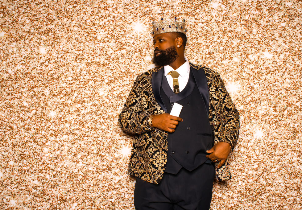 a man in a tuxedo with a crown on his head