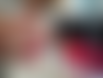 Woman's polished nails in white and pink next to a line of nail polish bottles