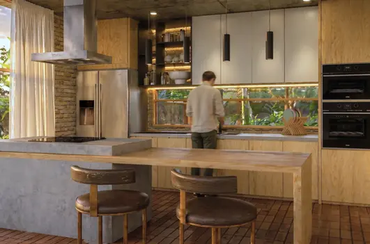 Diseño interior de cocina moderna con isla central y vista al paisaje natural en zona rural.