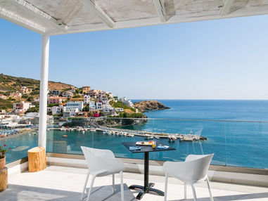 Terrace with table and chairs overlooking the sea and harbor