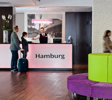 Hotel reception desk with guests checking in