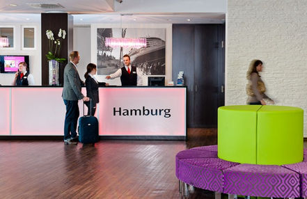 Hotel reception desk with guests checking in