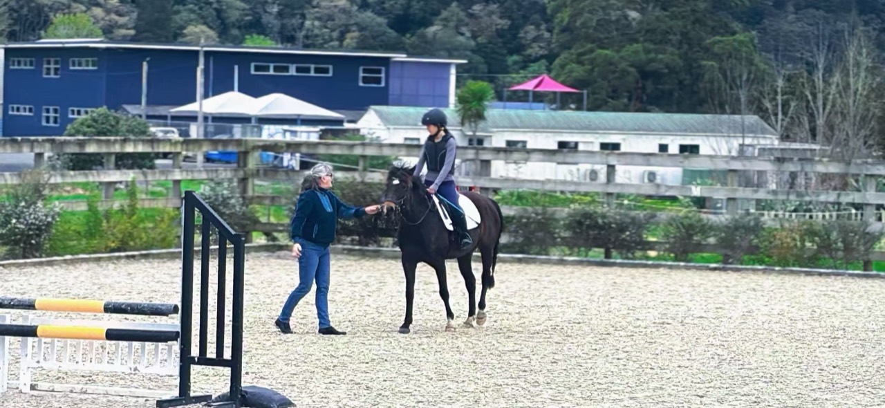 An instructor and rider working together during a Pegasus masterclass