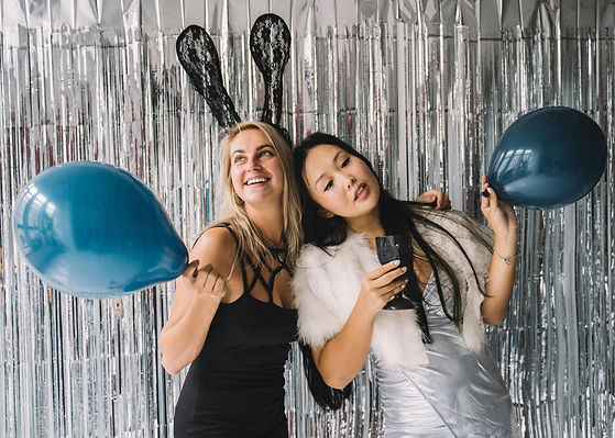 ladies posing in front of selfie booth
