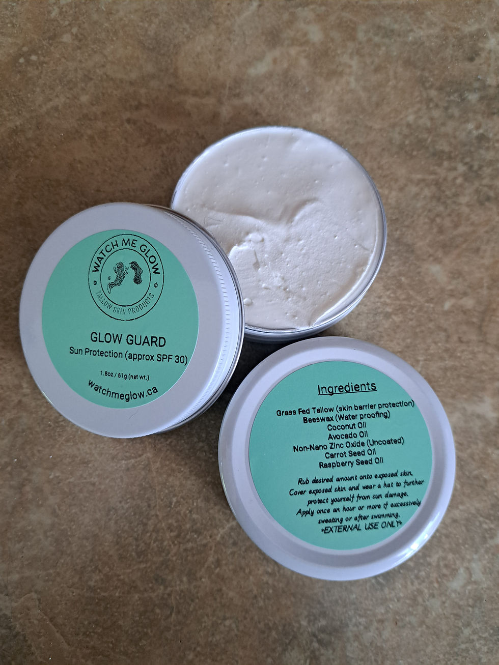 Three white cream jars display SLOW GUARD with text and ingredients, Bark to Basics.