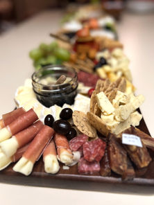 Luxury intimate charcuterie board featuring artisan cheeses, premium cured meats, seasonal fruit, crackers, and gourmet accompaniments, beautifully styled by Elevated Graze.