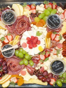 Charcuterie board featuring artisan cheeses, premium cured meats, seasonal fruit, gourmet crackers, and elegant presentation for a Denver business event.