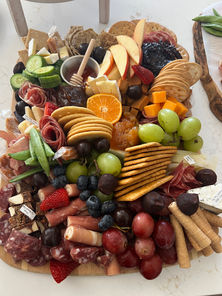 Classic charcuterie board featuring artisan cheeses, premium cured meats, seasonal fruit, gourmet crackers, nuts, and elegant styling by Elevated Graze.