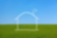 Blue sky and green grass with an outline of a house in the middle
