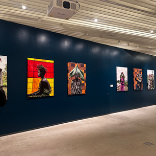 Gallery wall at MoCADA Fort Greene featuring large-scale photographic portraits from Shani Crowe's Red Black and Green exhibition, displayed on a deep navy blue wall