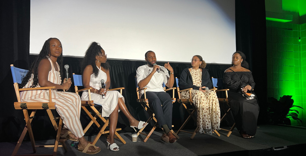 A group of men and women on a panel conversation about filmmaking