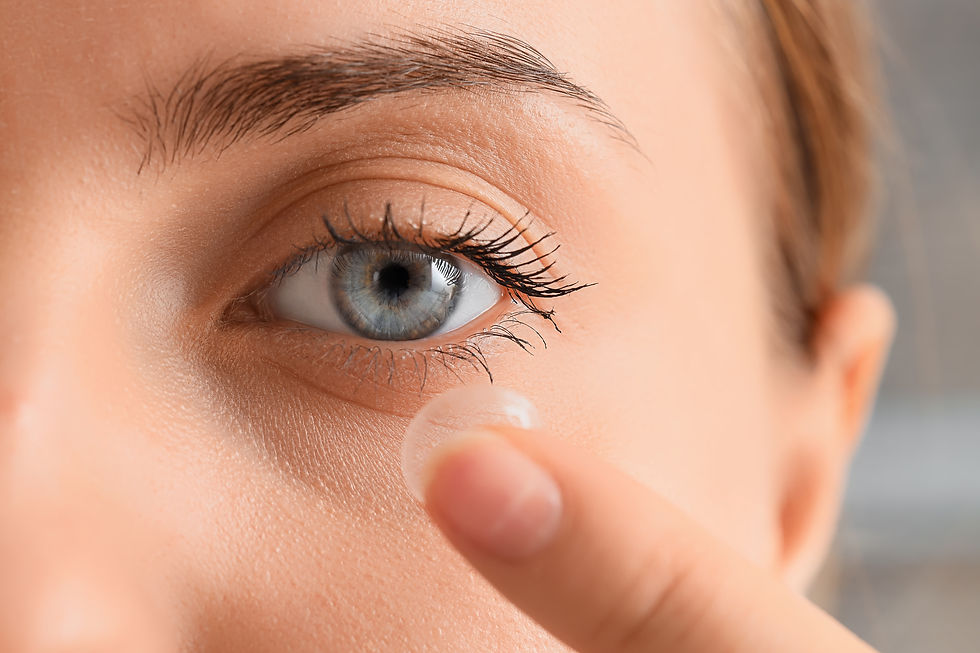 Beautiful young woman putting in contact lenses at home, closeup.jpg