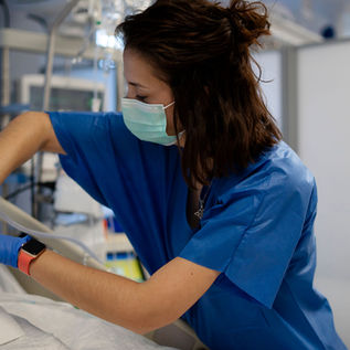 Nurse in blue scrubs providing care to a patient—representing future Native American leaders in healthcare through OSU’s Nursing Leadership Program.