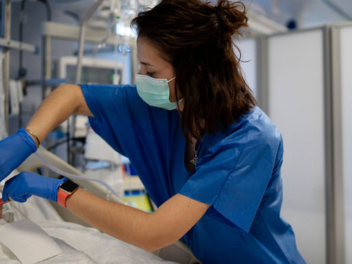 Nurse in blue scrubs providing care to a patient—representing future Native American leaders in healthcare through OSU’s Nursing Leadership Program.