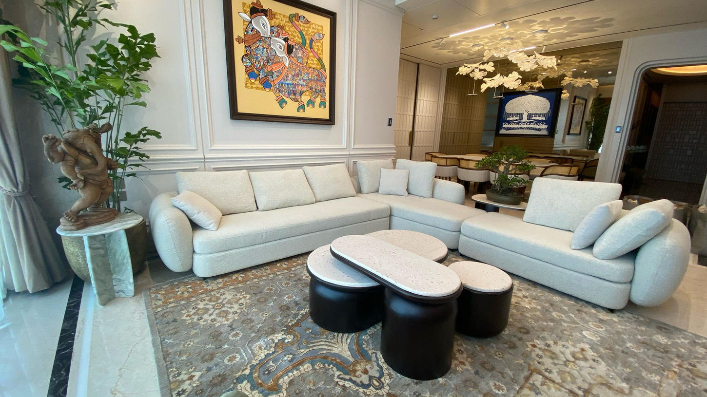 Modern beige Italian leather recliner sofa in a luxury Mumbai apartment living room, featuring ergonomic lumbar support and custom bespoke finish by SOISU