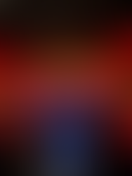 DJ in a blue shirt at the Ministry of Sound, facing a lively crowd under red lights. DJ booth with turntables, energetic atmosphere.