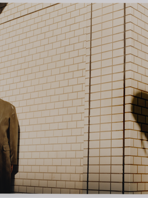 DJ Hell standing in front of a wall