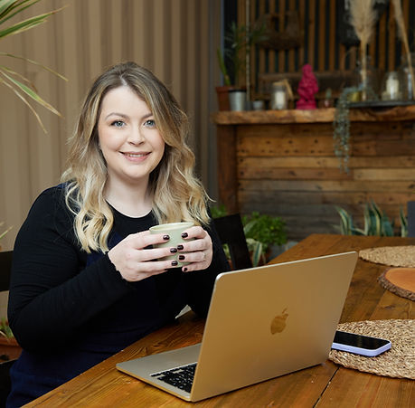 Emma your virtual assistant sat at her laptop with a coffee