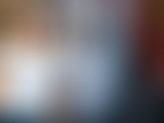 Jo leaning casually against a vibrant graffiti wall.