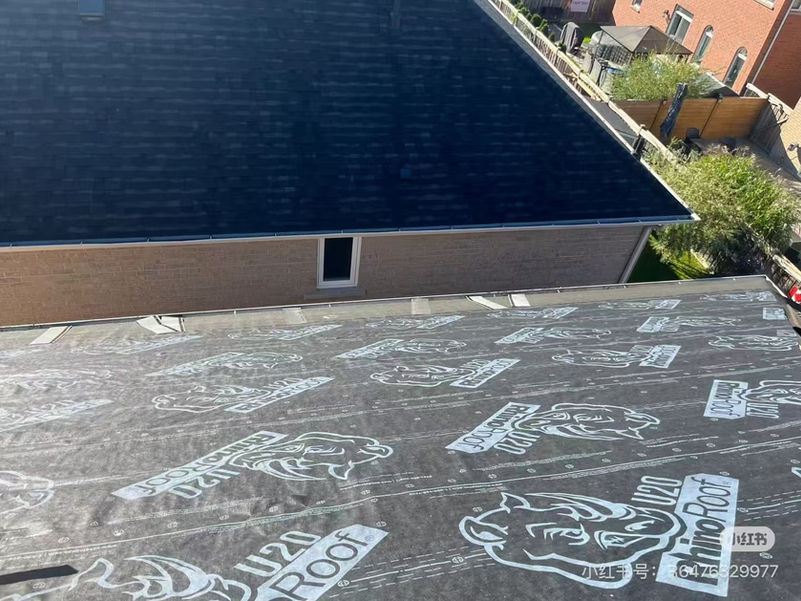 A roof deck in Burlington covered with RhinoRoof U20 synthetic underlayment before shingle installation, showing professional waterproofing preparation.