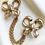 Thumbnail: Yves Saint Laurent vergulde dubbele strikjes broche